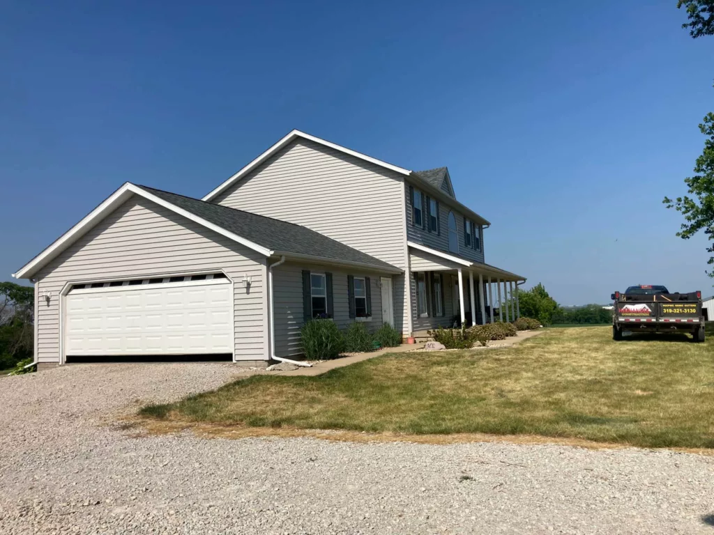 Garage and home with a new roof in Tipton, Iowa