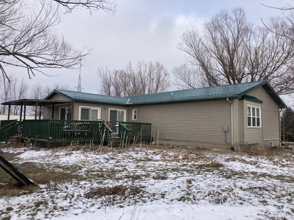Inspection of the hail damaged metal roof in West Branch, Iowa