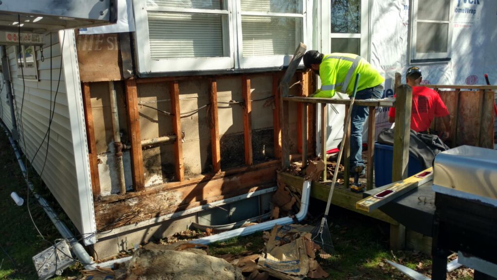 Crew working on water damaged wall on a home in Muscatine, Iowa