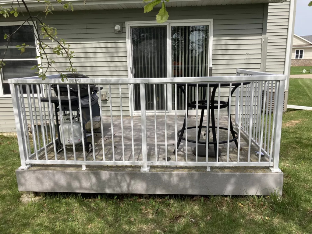 Deck on a Home with Storm-Damaged Siding, Shingles, Gutters, and Downspouts in Tipton, Iowa