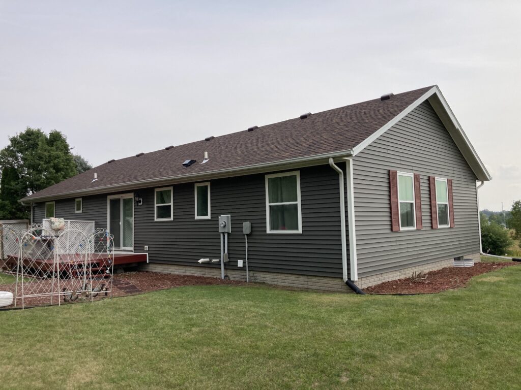 Finished view of Roofing Shingles, Vinyl Siding, Gutters and Downspouts Removed and Replaced in West Branch, Iowa. Side of home