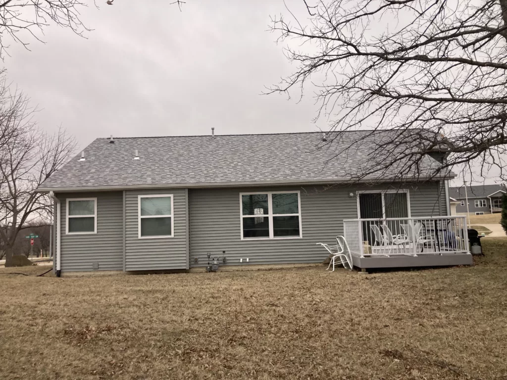 Finished view of replaced siding, shingles, gutters, and downspouts on a home in Tipton, Iowa (back of home)