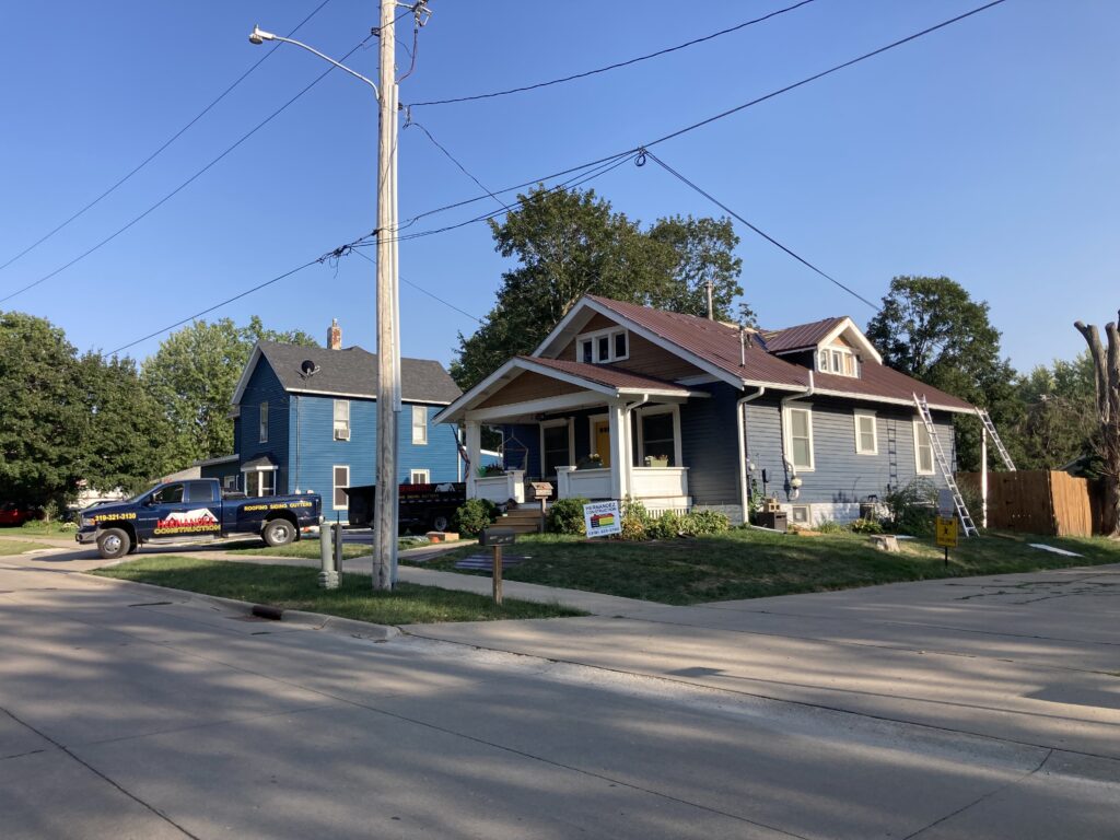 Finishing the new metal roof installation for on a home in West Liberty, Iowa