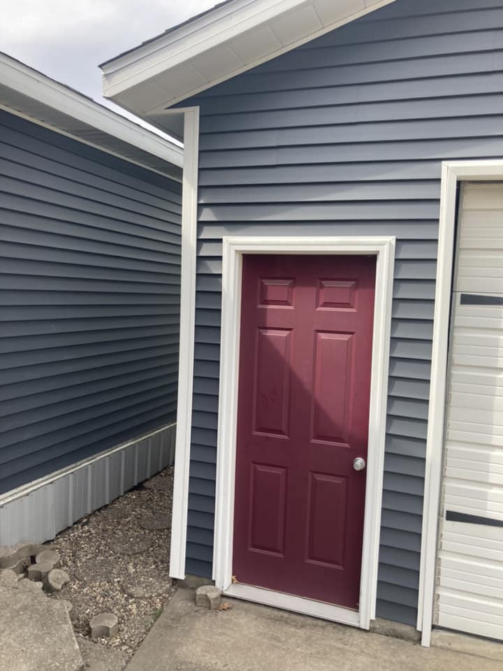 New vinyl siding installed by the side door on a home in Durant, Iowa