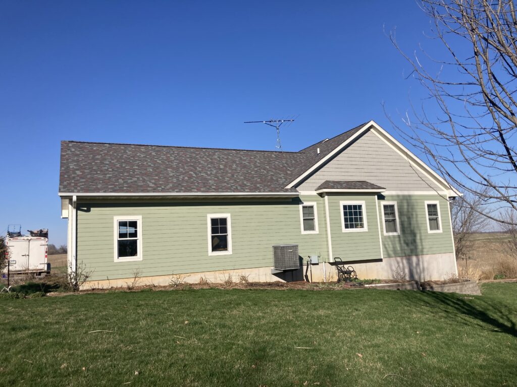 Wind and hail damaged roof is removed with new asphalt shingles installed in West Branch, Iowa.