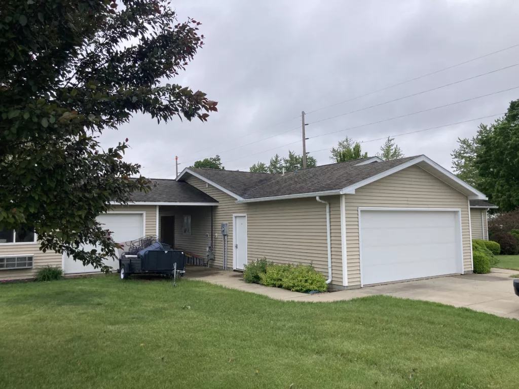 Original roof with missing asphalt shingles due to wind and hail damage roof in Stanwood, IA