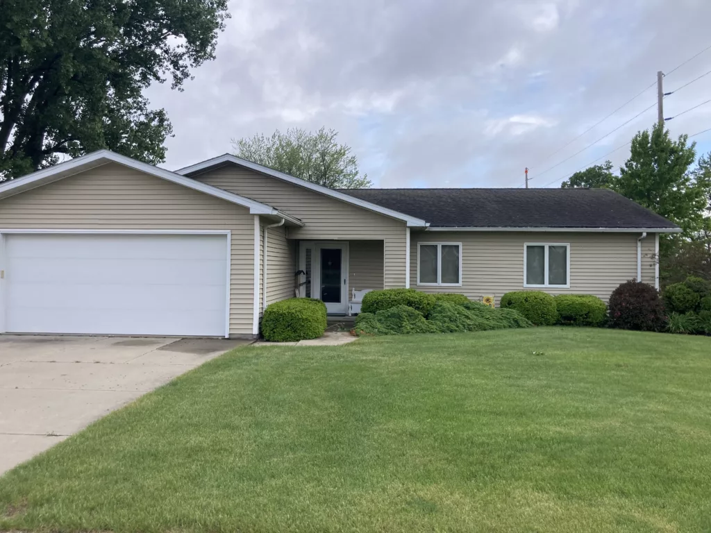 Original roof with missing asphalt shingles due to wind and hail damage roof in Stanwood, Iowa