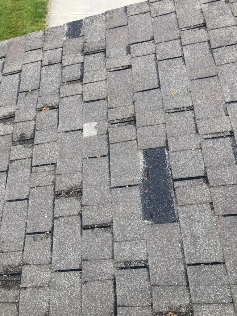 Asphalt Shingles are missing from this wind and hail damage roof in Stanwood, Iowa