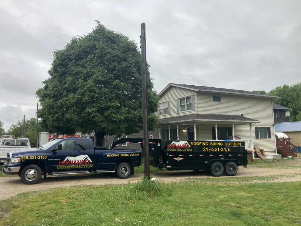 Finished roof - Hernandez KD Construction truck and trailer in from of the home in Davenport, Iowa