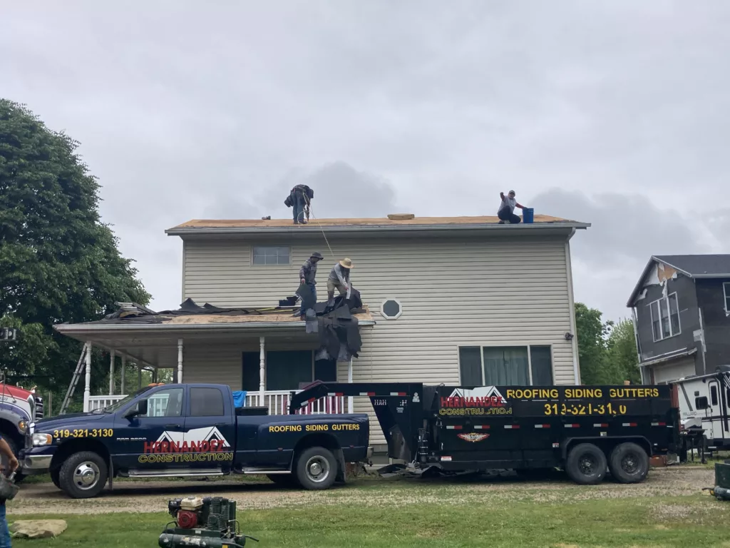 Hernandez KD Construction Crew removing the age-related damaged roof in Davenport, Iowa