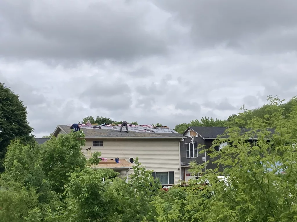 Hernandez KD Construction Crew removing the age-related damaged roof in Davenport, Iowa (back of the home)
