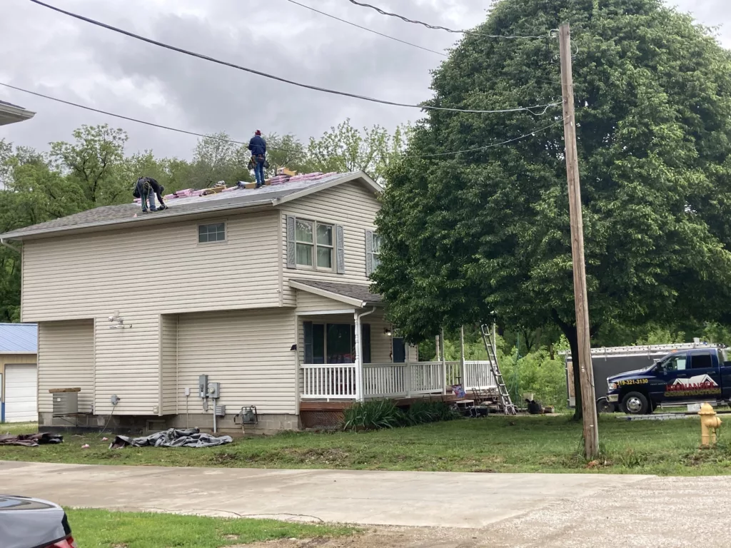Hernandez KD Construction Crew removing the age-related damaged roof in Davenport, Iowa. (side of the home)