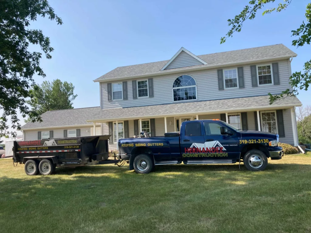 Hernandez KD Construction Truck in front of a house with Home Roof & Roof Decking Replacement in Tipton, Iowa