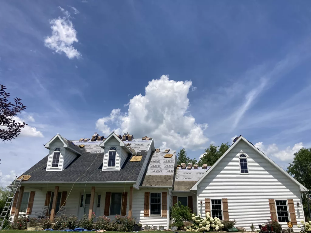 Hernandez KD Construction working on a roof in Tipton, Iowa (front of home)
