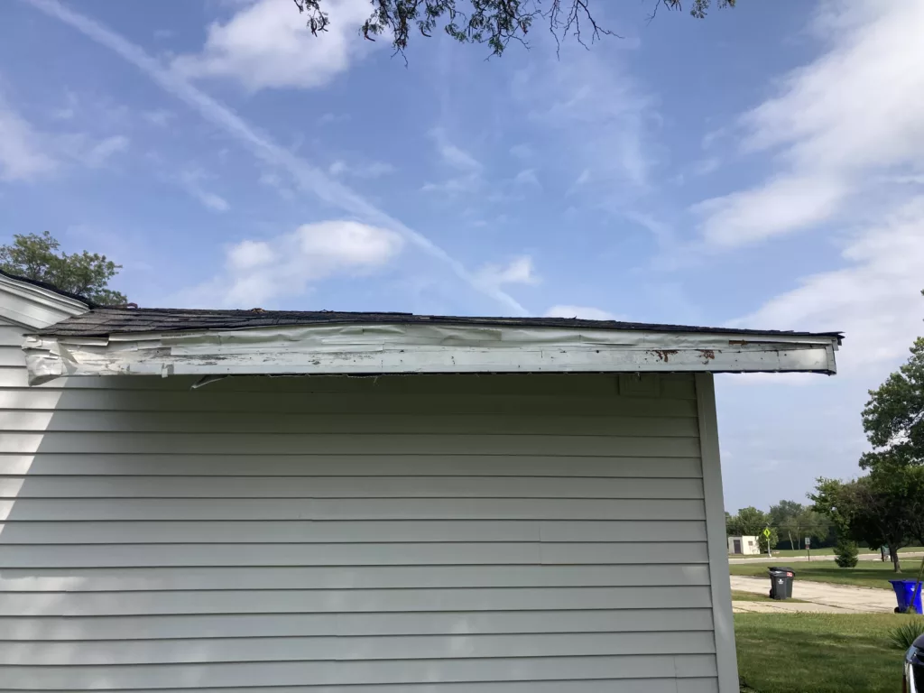 Sagging roof due to rafter damage and tape is in place to stop wildlife from entering the roof in Cedar Rapids, Iowa