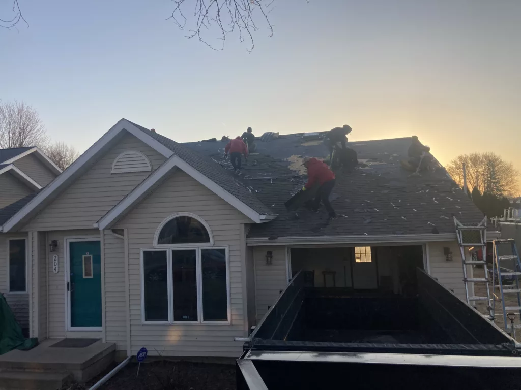 Crew cleaning off the Storm Damaged Roof in Tipton, Iowa