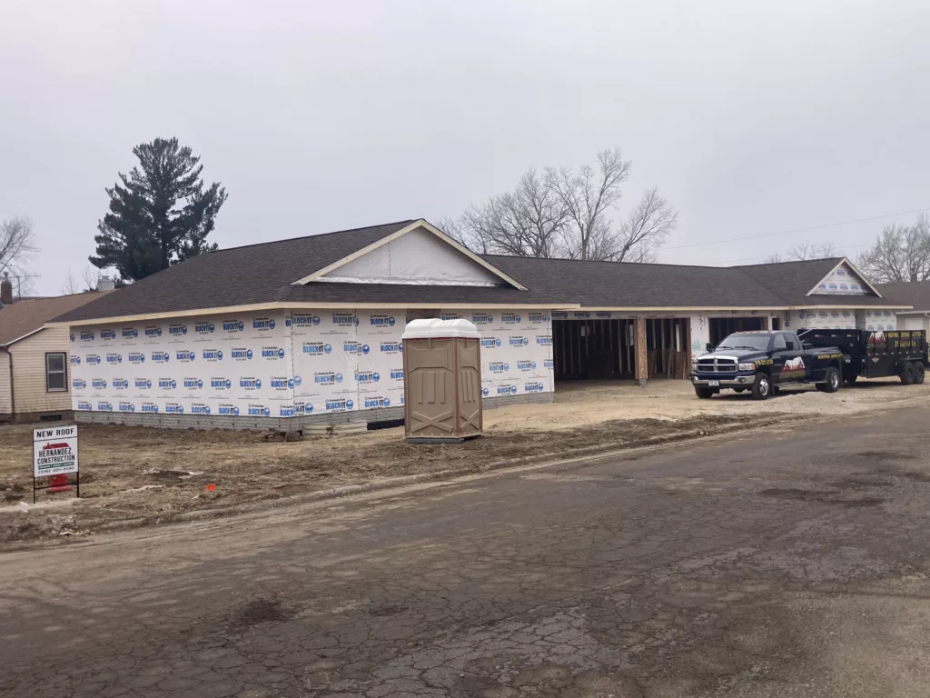 New roof on the newly Photos of the roofing crew at Hernandez KD Construction at a duplex in Tipton, Iowa - Hernandez KD Construction yard sign
