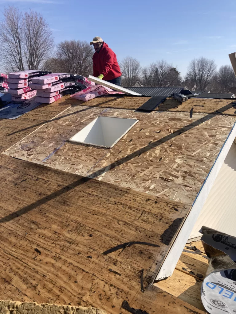 Replaced roof decking with skylight on a storm damaged roof in Tipton, Iowa