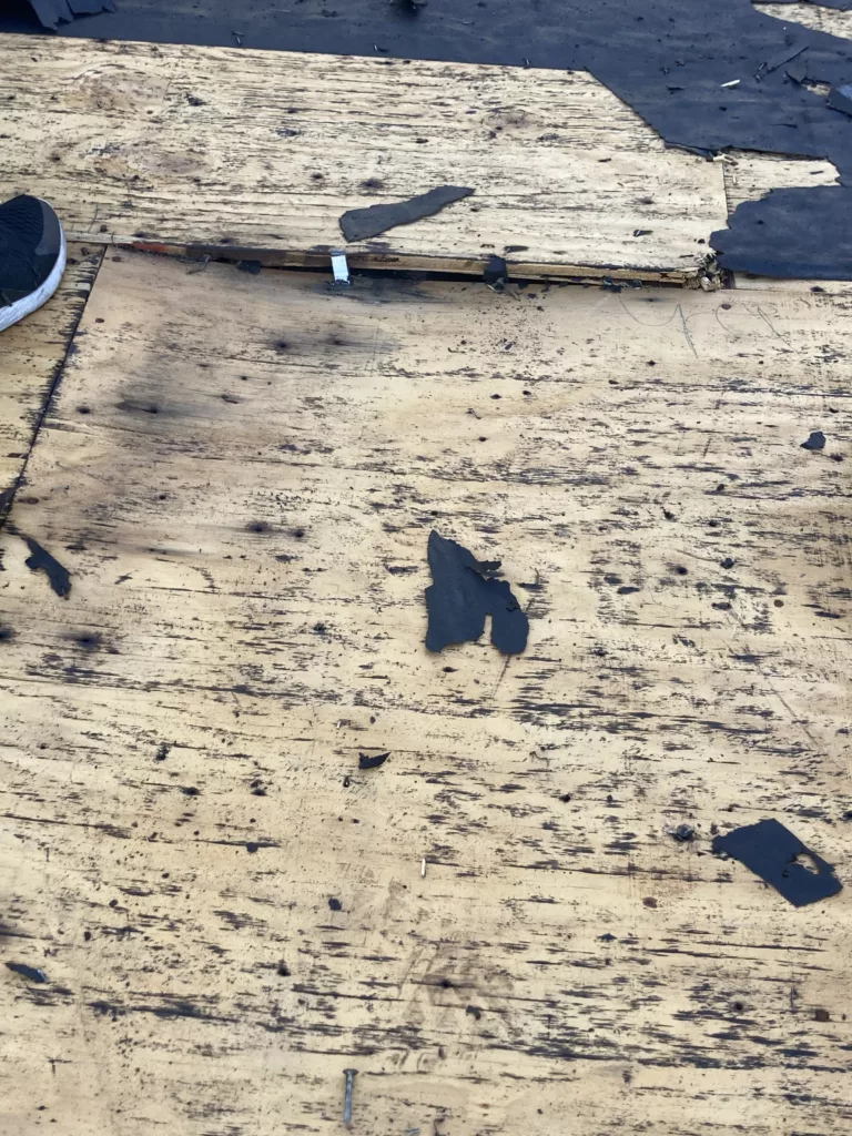Rotting roof decking with structural issues on a home in Tipton, Iowa