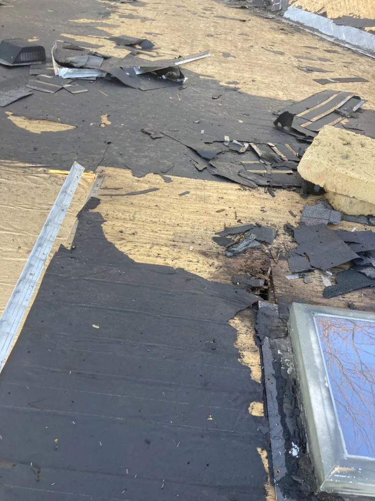 Storm and water damaged roof decking on a home in Tipton, Iowa