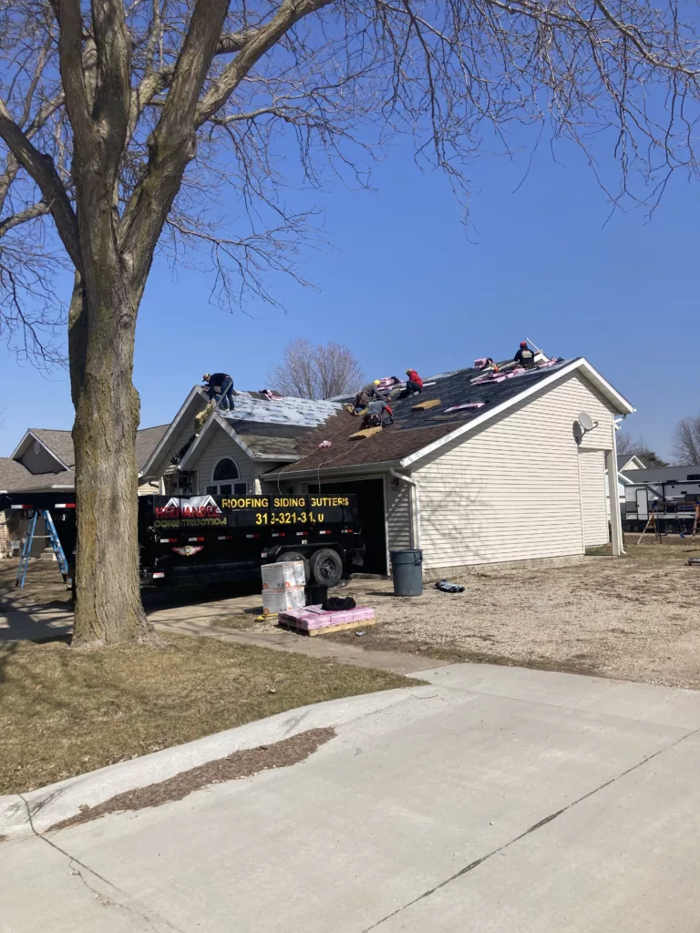 The crew is woring on the storm damaged roof in Tipton, Iowa