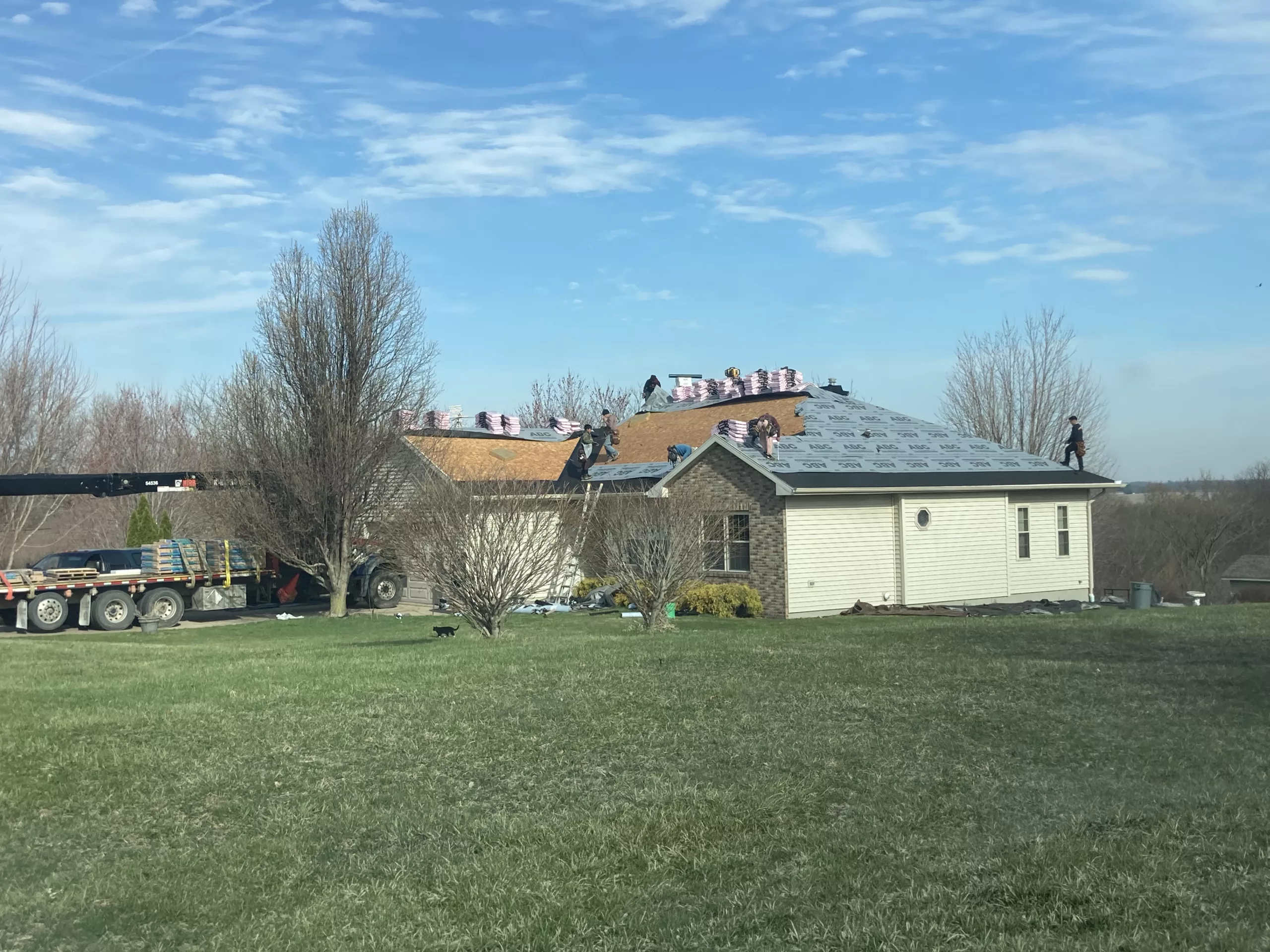 Crew working on Wind & Hail Damaged Roof with Shingle Removal and Replacement, in Tipton, Iowa